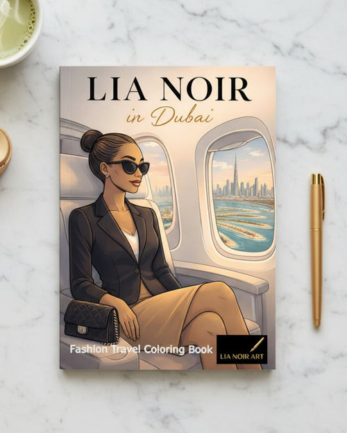 Book titled 'Lia Noir in Dubai' on a marble surface with a cup of tea and pen.